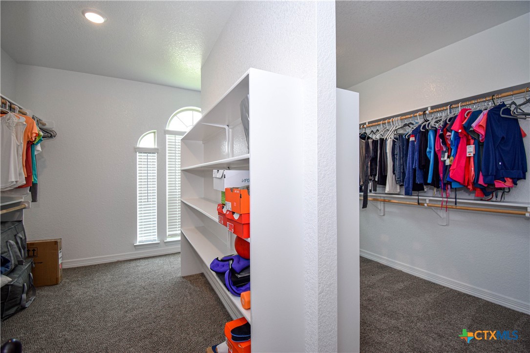 7623 Palladium Loop Killeen, TX 76542 - Photo 34 of 48 a view of walk in closet with clothes and shoes