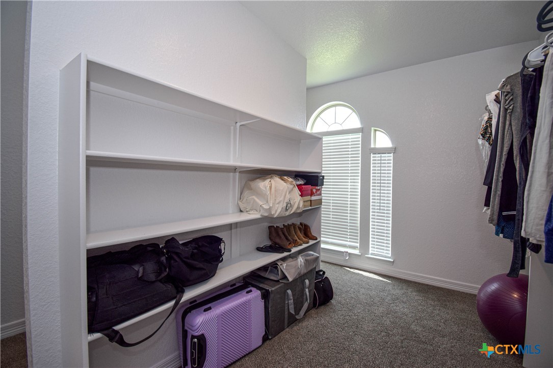 7623 Palladium Loop Killeen, TX 76542 - Photo 35 of 48 a view of walk in closet with clothes and shoes