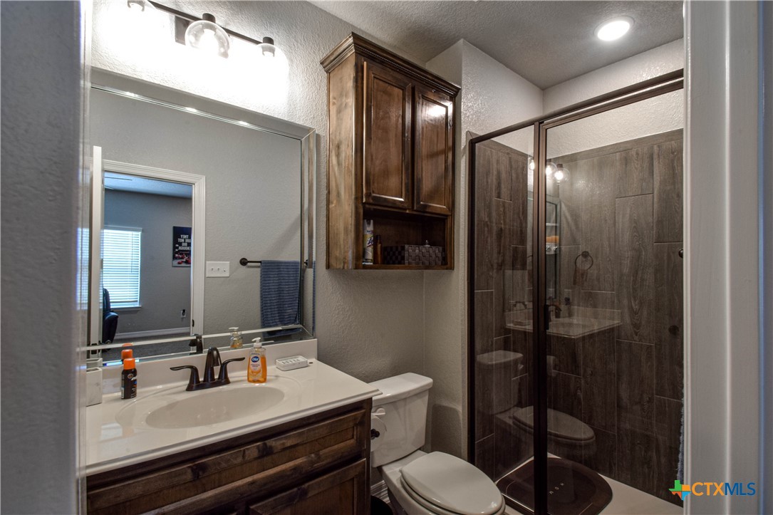 7623 Palladium Loop Killeen, TX 76542 - Photo 39 of 48 a bathroom with a sink a toilet a mirror and shower