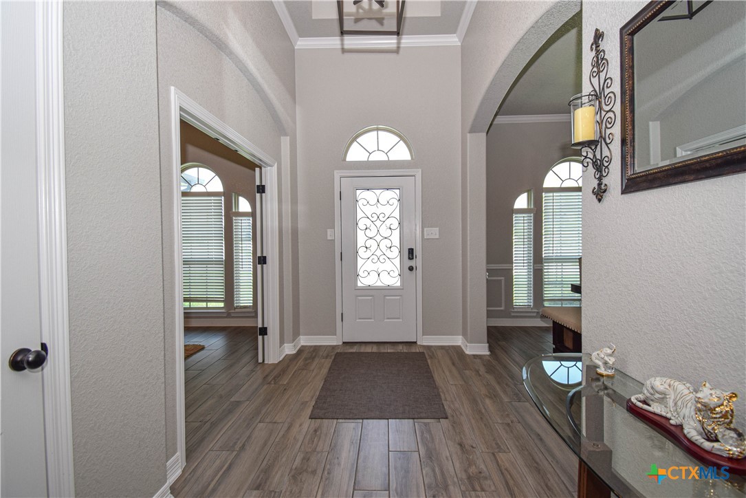 7623 Palladium Loop Killeen, TX 76542 - Photo 6 of 48 a view of a hallway with wooden floor and a chandelier