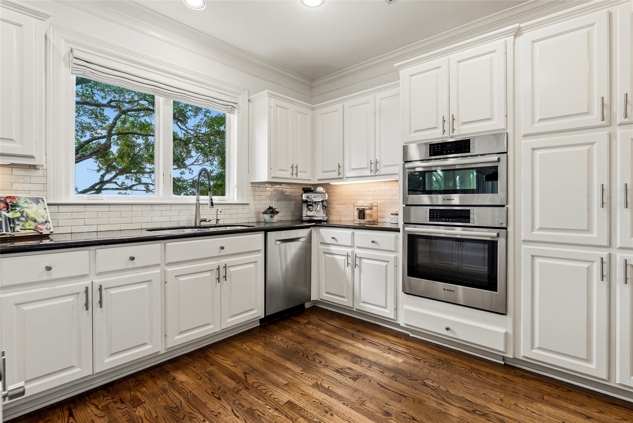 3107 Lookout Lane Austin, TX 78746 - Photo 19 of 39 Culinary aspirations find their home in this well-appointed kitchen featuring gleaming hardwood floors and sleek stainless steel appliances.