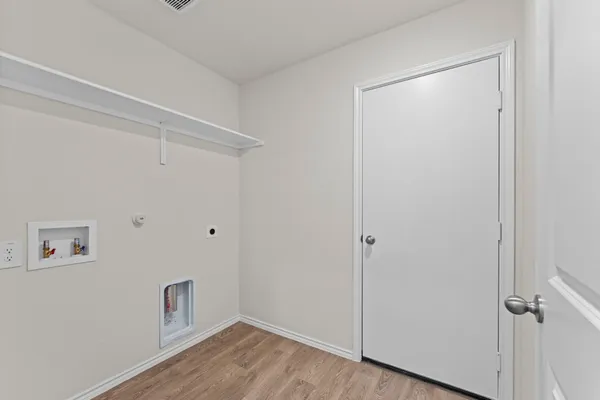 a view of a room with wooden floor