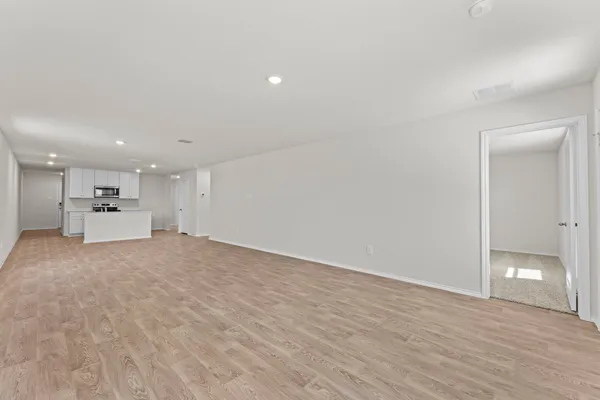 a view of a kitchen with a sink and a refrigerator
