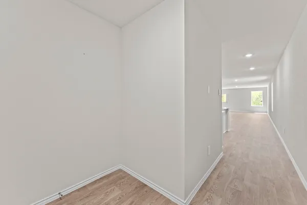 a view of a hallway with wooden floor