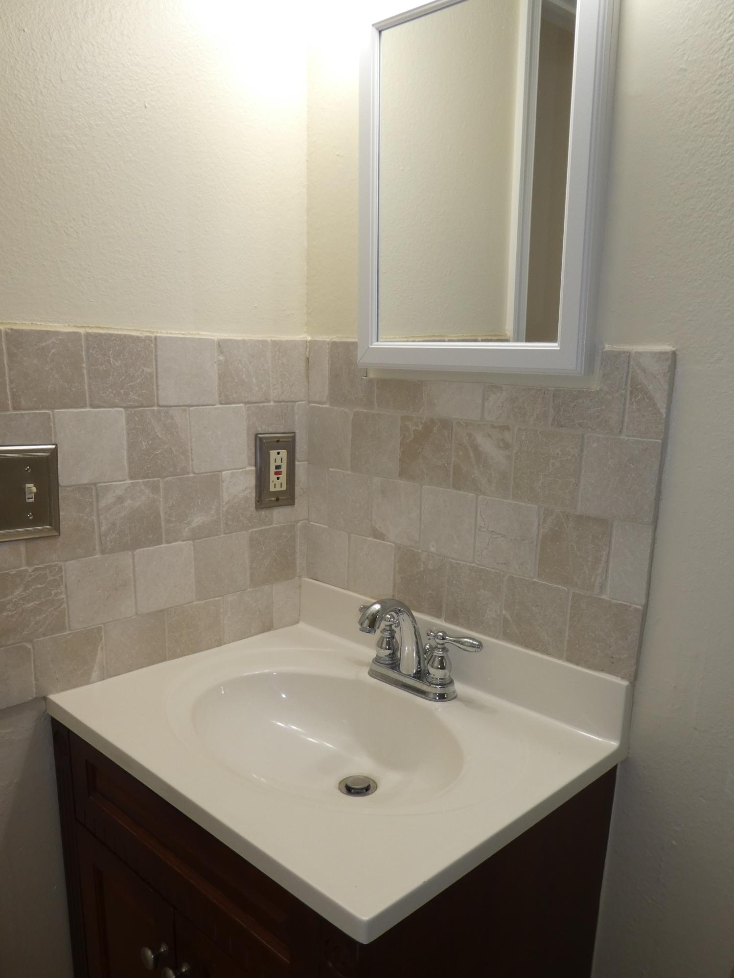 9855 Sandalfoot Boulevard, Unit 306 Boca Raton, FL 33428 - Photo 12 of 25 a bathroom with a sink and a mirror