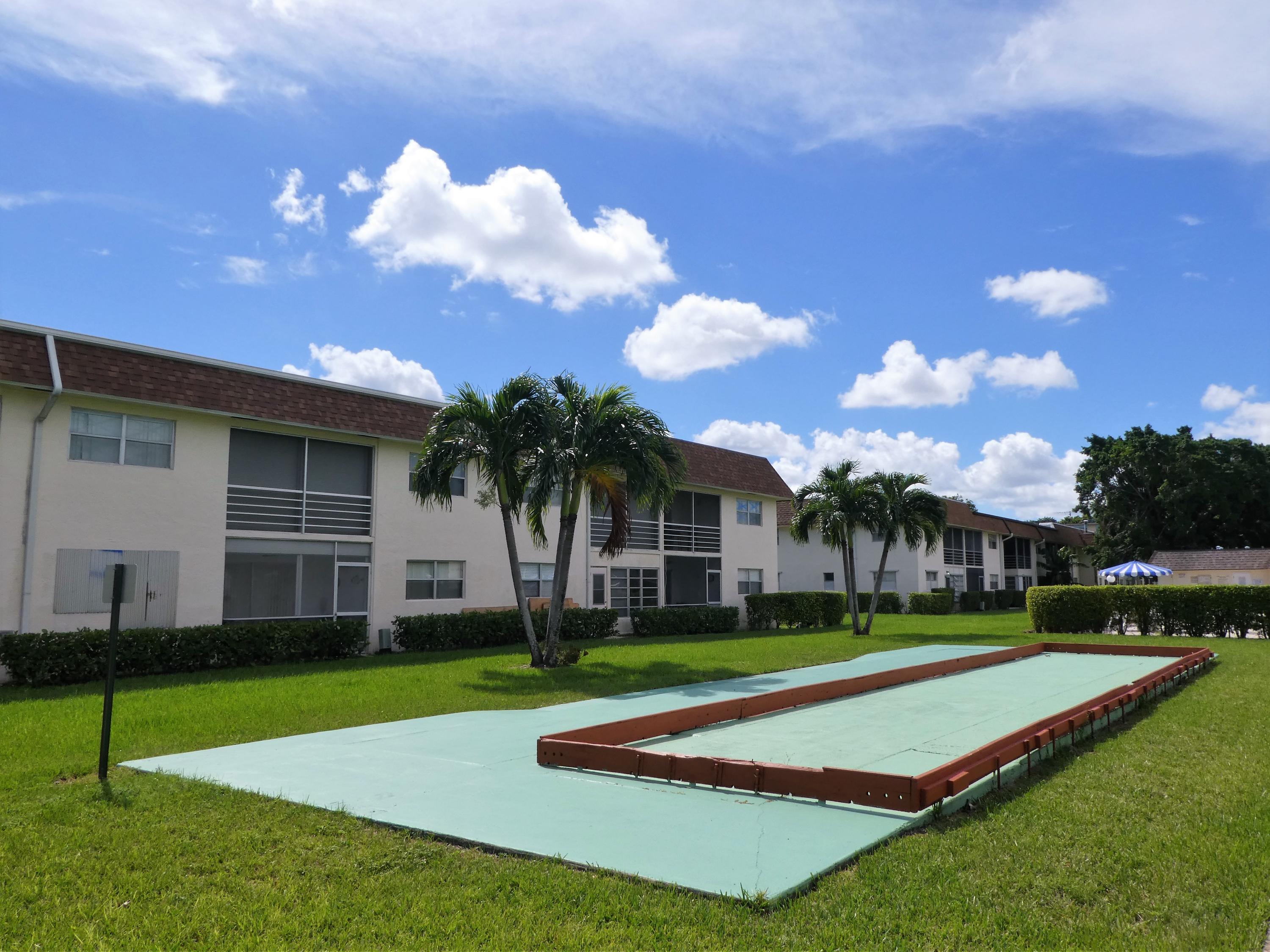 9855 Sandalfoot Boulevard, Unit 306 Boca Raton, FL 33428 - Photo 15 of 25 a house view with a garden space
