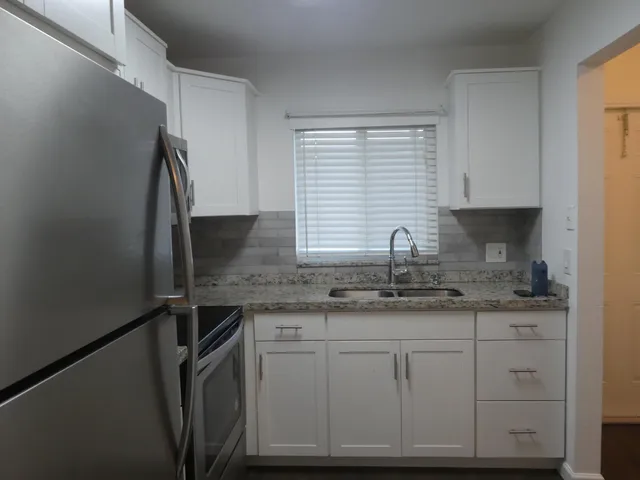 a kitchen with a sink and cabinets