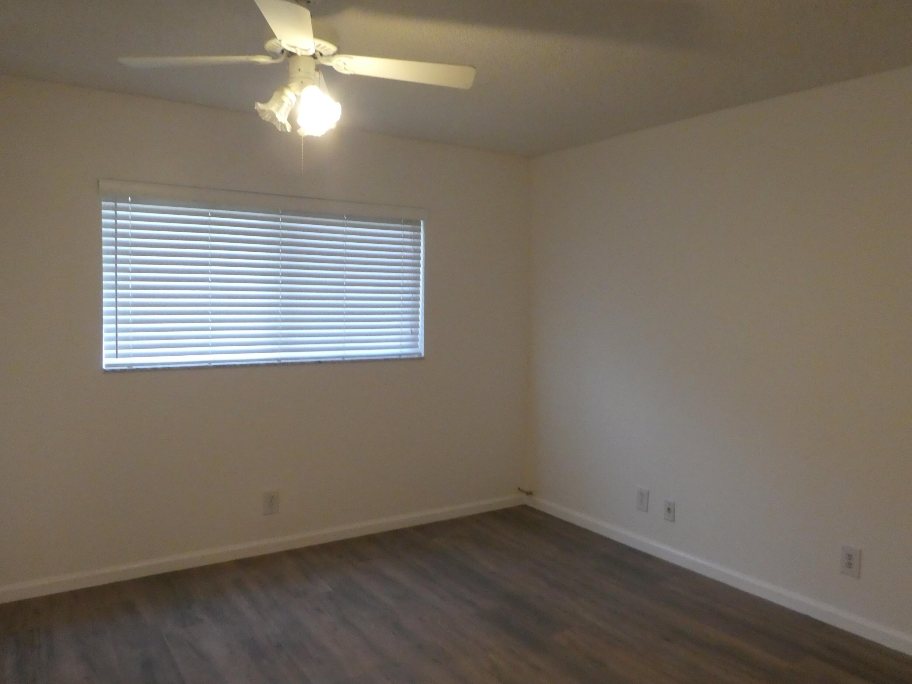 9855 Sandalfoot Boulevard, Unit 306 Boca Raton, FL 33428 - Photo 6 of 25 an empty room with a window