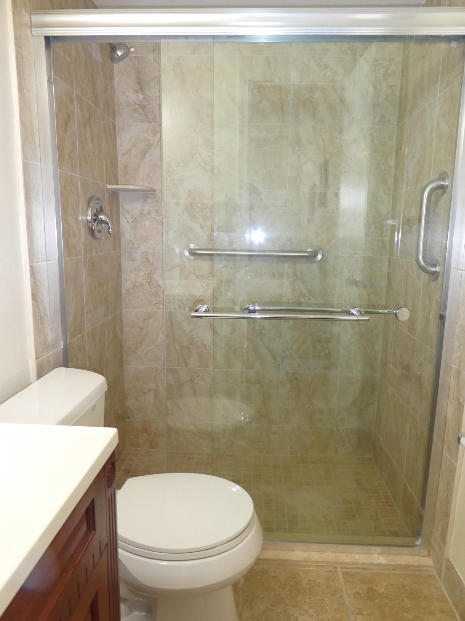 9855 Sandalfoot Boulevard, Unit 306 Boca Raton, FL 33428 - Photo 8 of 25 a bathroom with a shower a toilet and sink