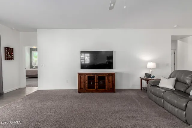 a living room with furniture and kitchen view
