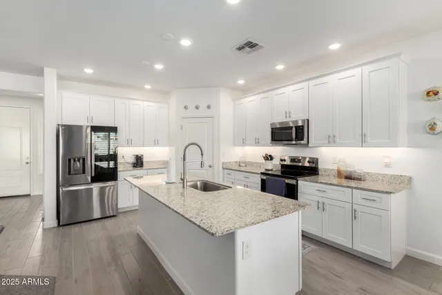 a dining room with furniture a chandelier and window