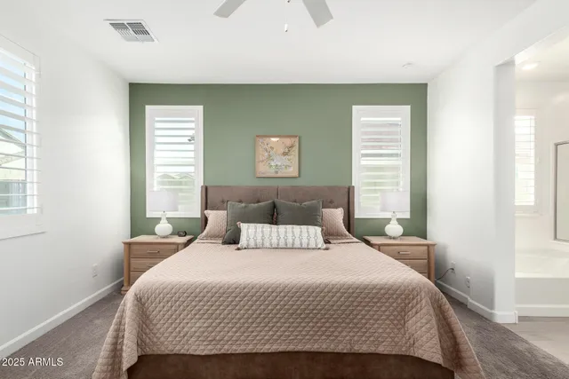 a large kitchen with granite countertop a sink white cabinets and stainless steel appliances