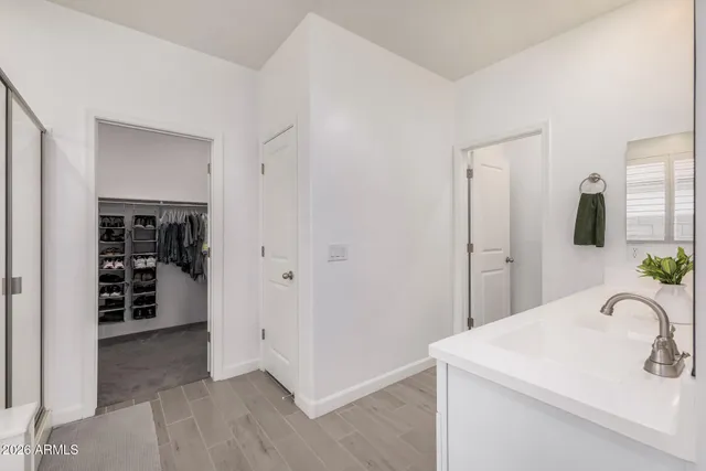 a bathroom with a double vanity sink bathtub and next to a window