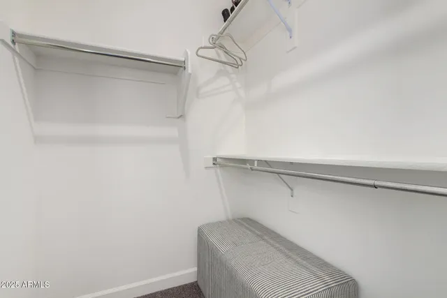 a bedroom with a bed and cupboard