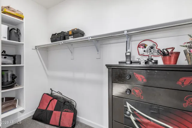 a utility room with lots of different colored cloths