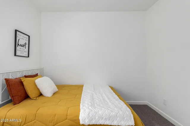 a bedroom with a bed and cupboard