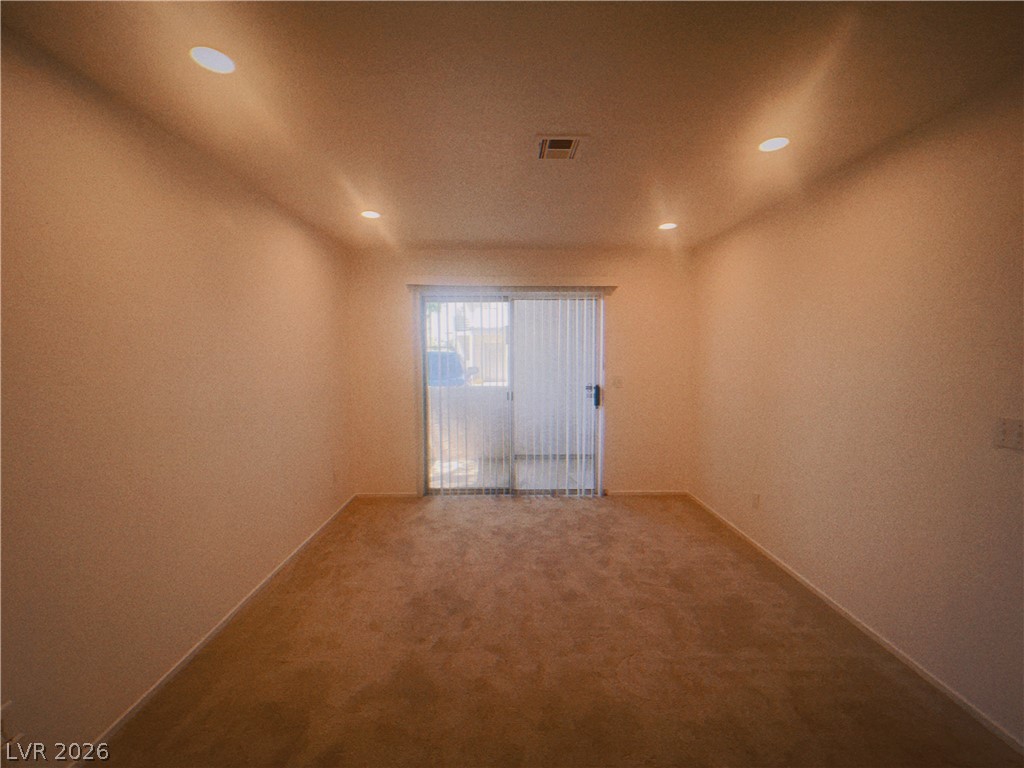 6250 West Flamingo Road, Unit 60 Las Vegas, NV 89103 - Photo 9 of 23 This living area features plush carpeting and recessed lighting, with a glass sliding door providing ample natural illumination.