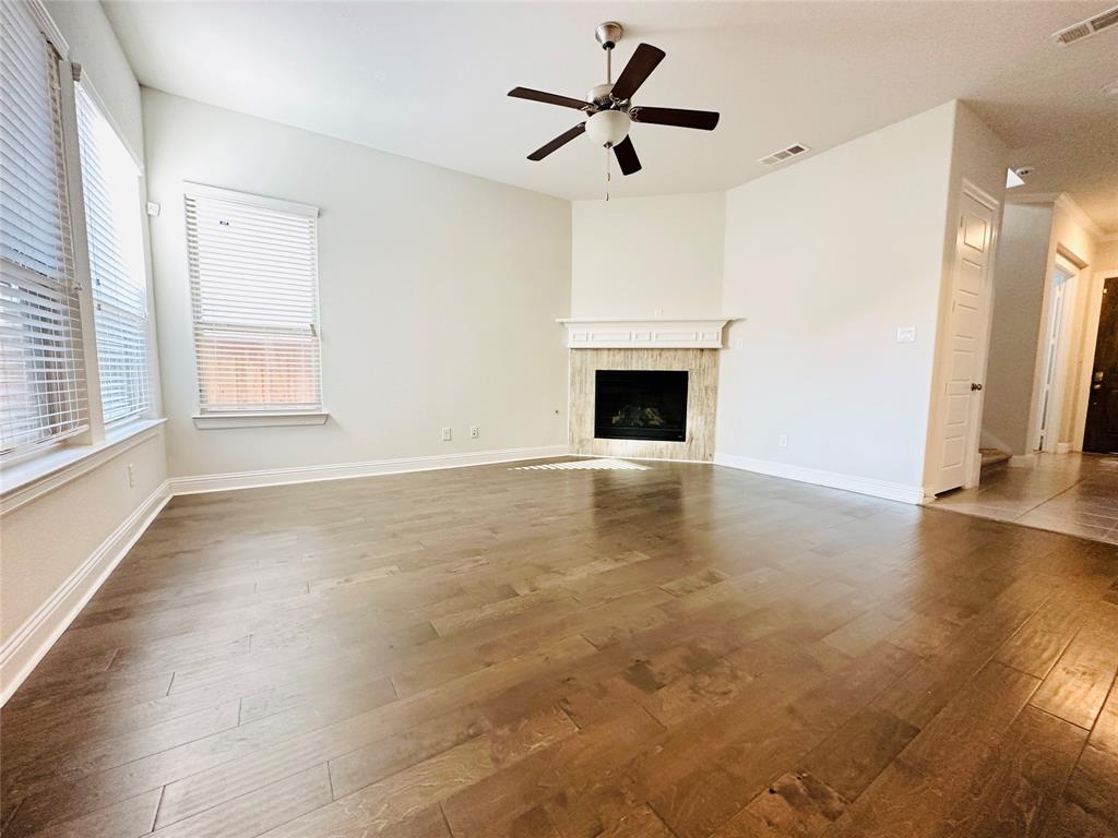 806 Davids Way Allen, TX 75013 - Photo 5 of 24 a view of empty room with wooden floor and fan