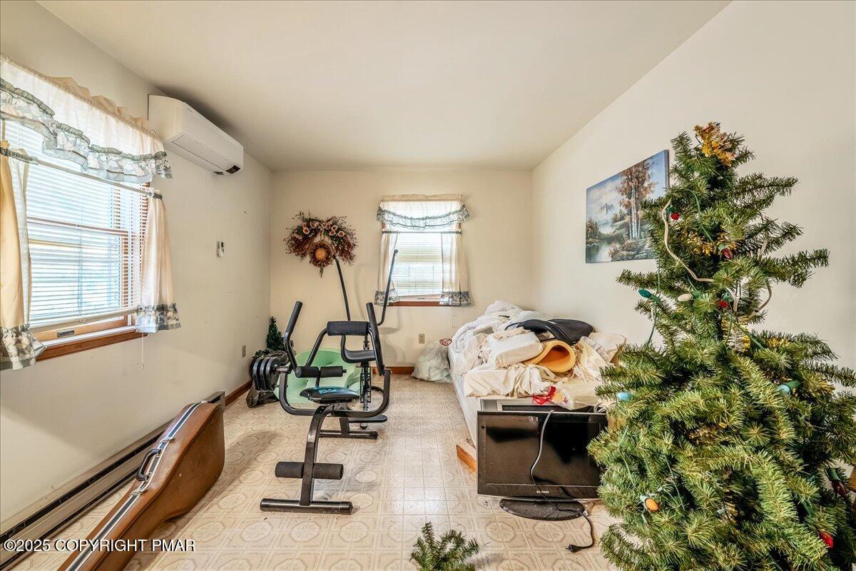 584 Pheasant Road Saylorsburg, PA 18353 - Photo 11 of 21 a living room with furniture and a chandelier