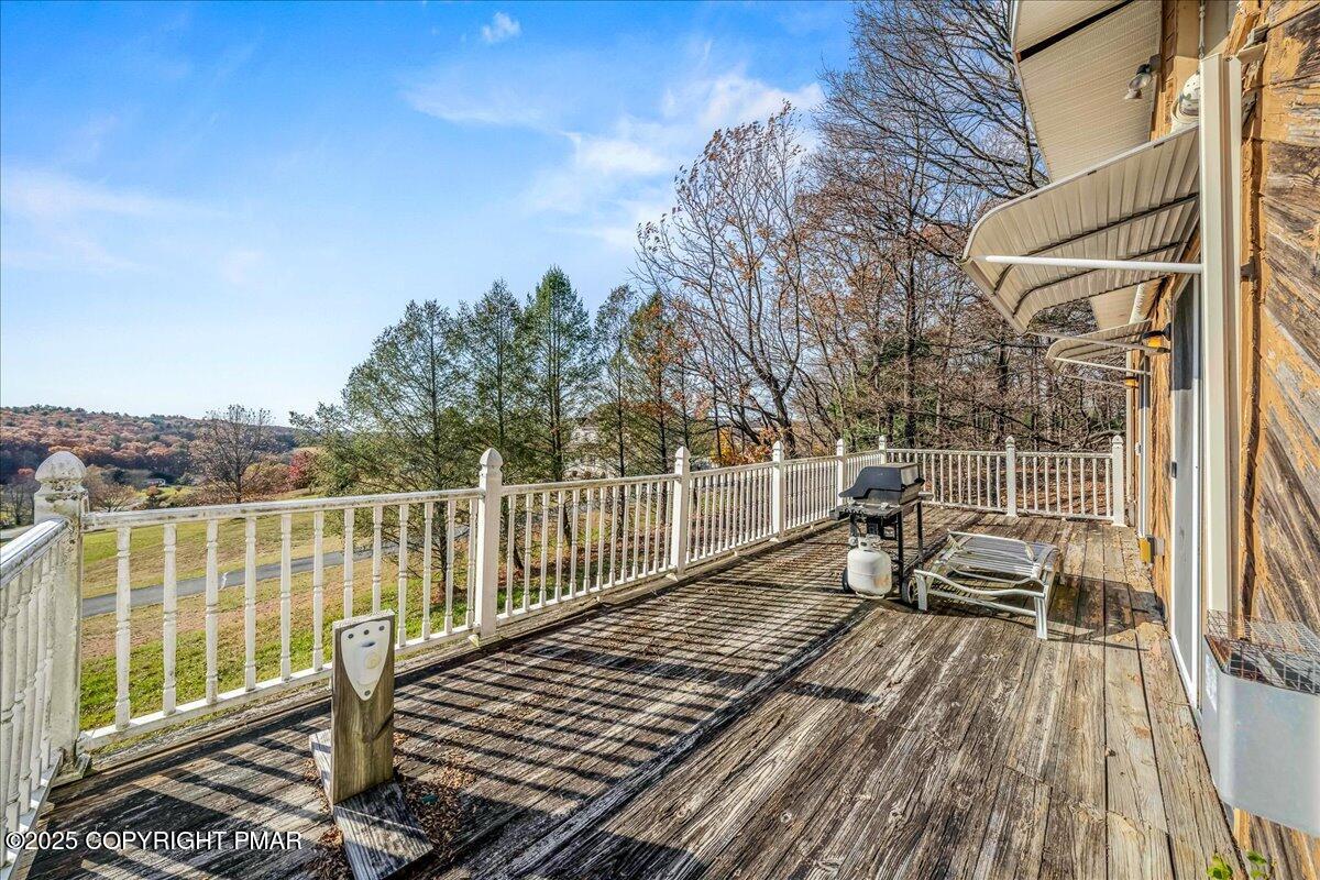 584 Pheasant Road Saylorsburg, PA 18353 - Photo 17 of 21 a view of a roof deck with wooden floor and fence