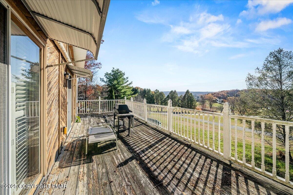584 Pheasant Road Saylorsburg, PA 18353 - Photo 2 of 21 a view of balcony with wooden floor and fence