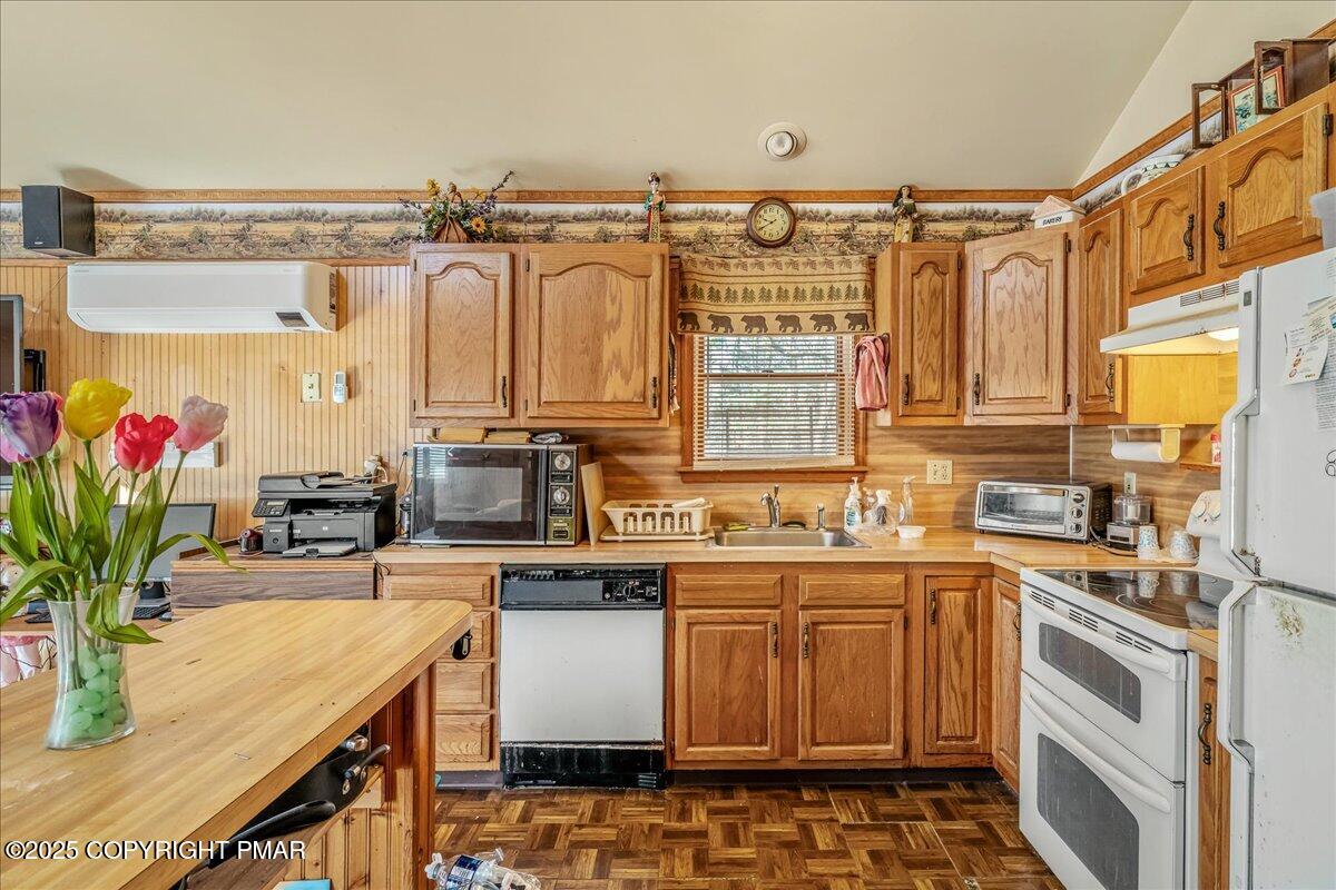 584 Pheasant Road Saylorsburg, PA 18353 - Photo 7 of 21 a kitchen with stainless steel appliances kitchen island granite countertop a sink a stove and a wooden floors