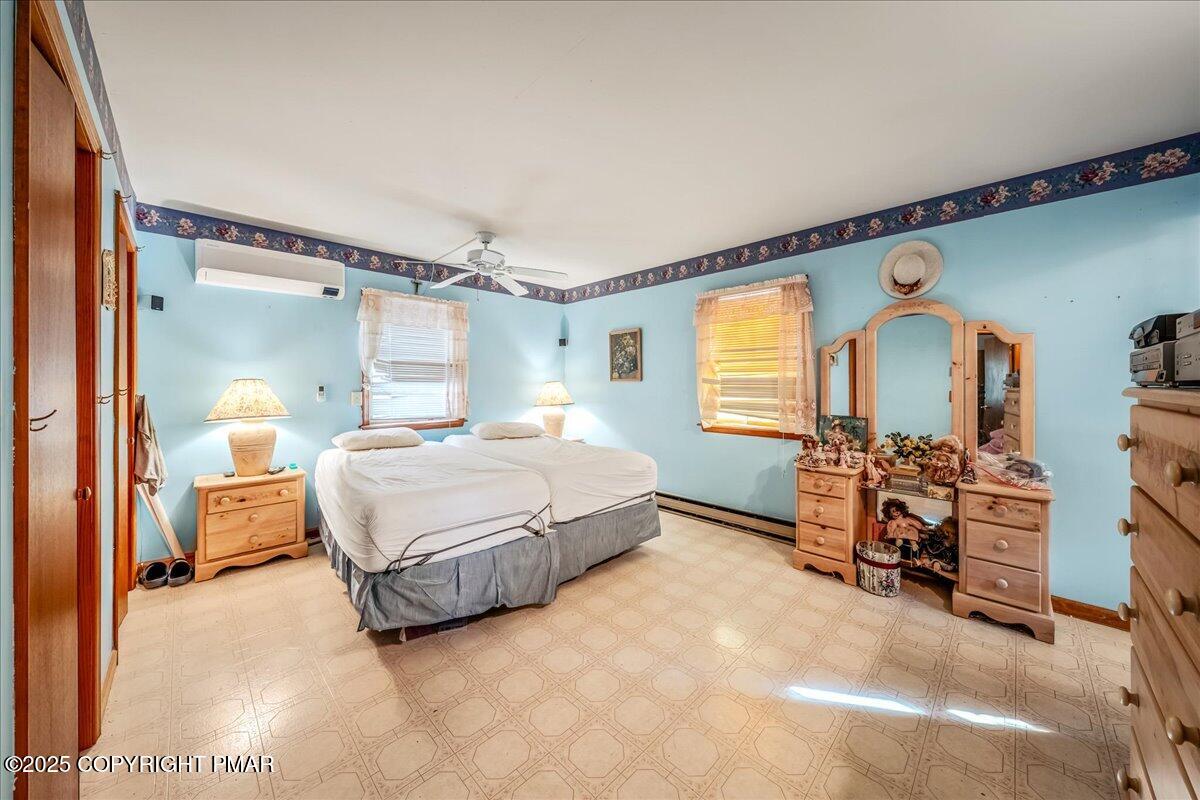 584 Pheasant Road Saylorsburg, PA 18353 - Photo 8 of 21 a spacious bedroom with a bed and a chandelier