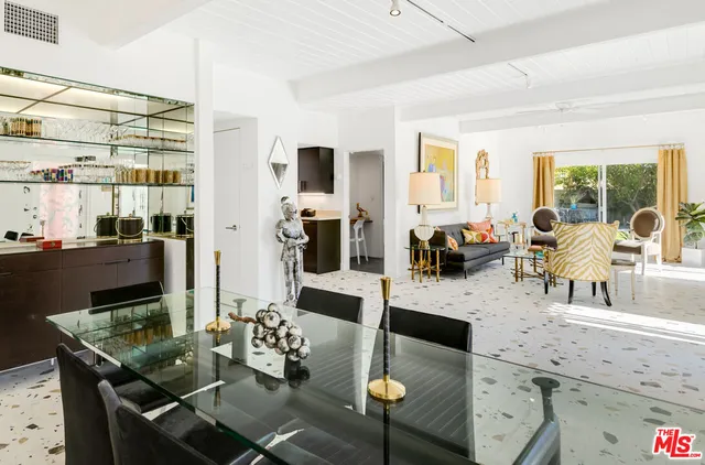 a living room with furniture and painting on the wall