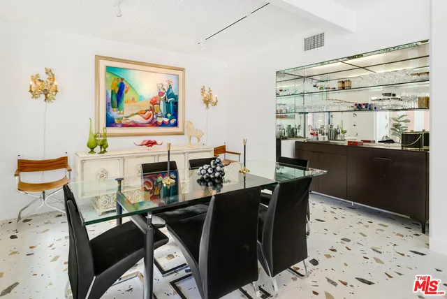 a kitchen with a refrigerator and a table