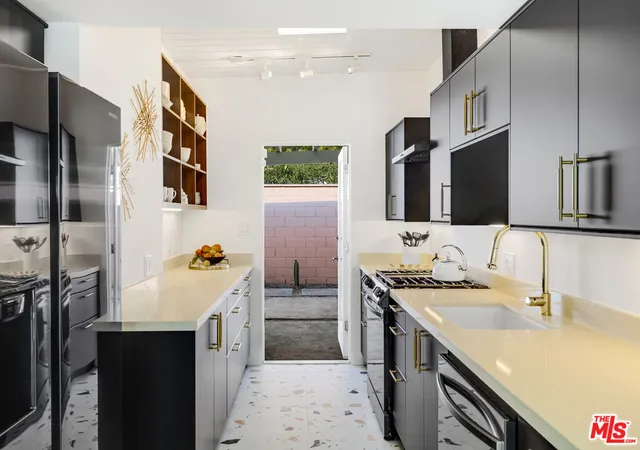 a kitchen with stainless steel appliances a sink stove and cabinets