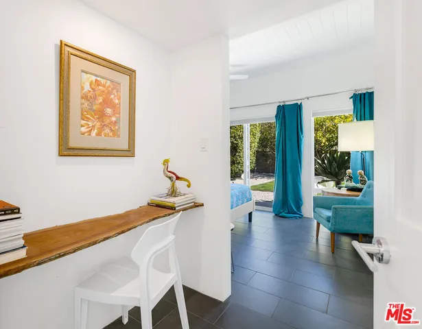 a bedroom with a bed and glass window