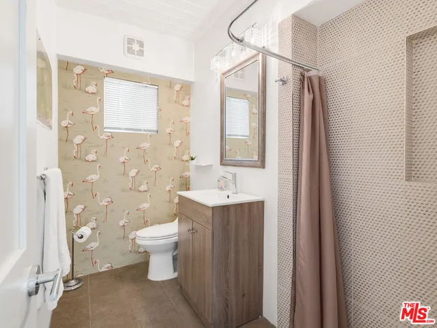 a view of a patio with a table chairs and a umbrella