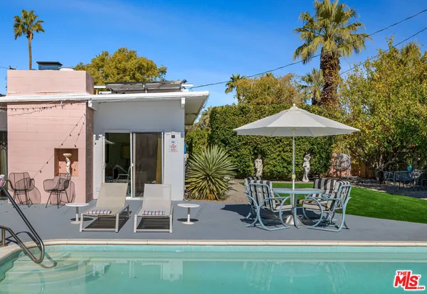 a view of a patio with swimming pool and furniture