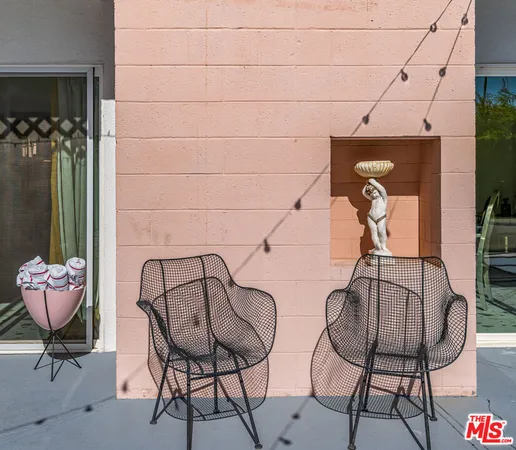 a patio with a table and chairs under an umbrella