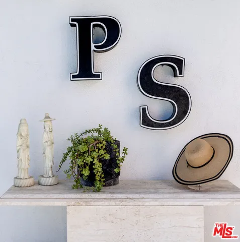 a patio with a table and chairs under an umbrella