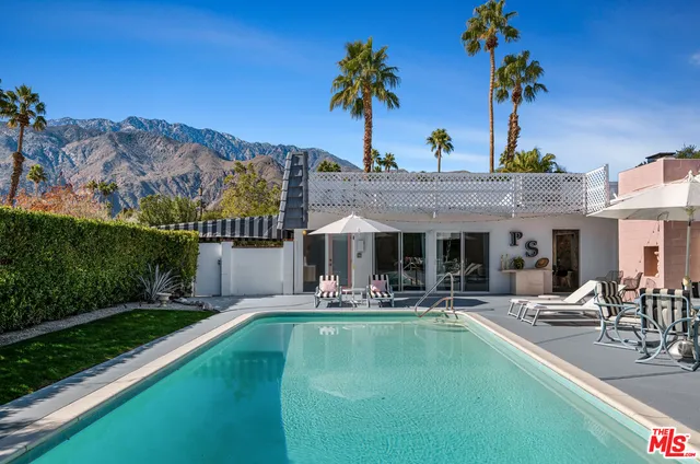 a swimming pool with outdoor seating yard and barbeque oven