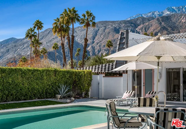 a backyard of a house with table and chairs