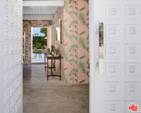 a view of a hallway with entryway wooden floor and front door