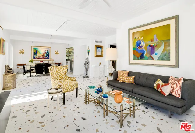 a living room with furniture and a lamp