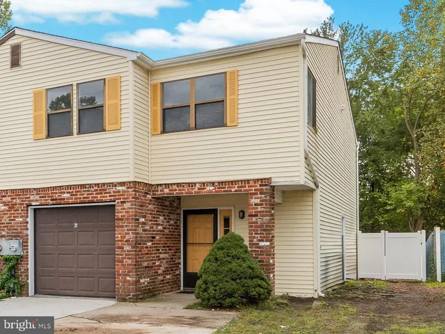 a view of a house with a yard and garage