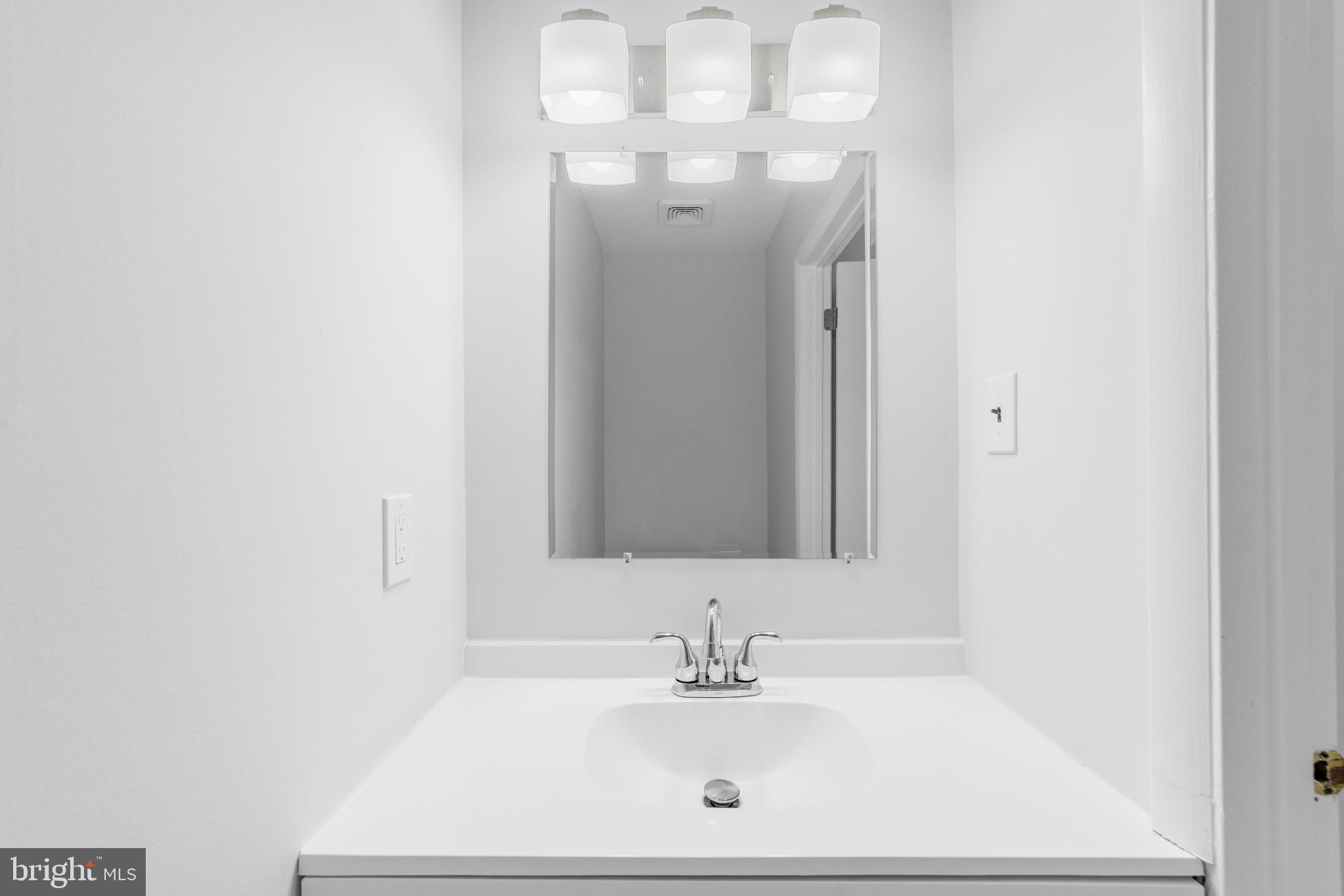 31 Phoenix Court Sewell, NJ 08080 - Photo 11 of 24 a bathroom with a sink a mirror and a vanity