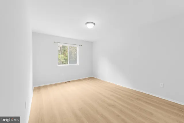 a view of a room with wooden floor and bathroom