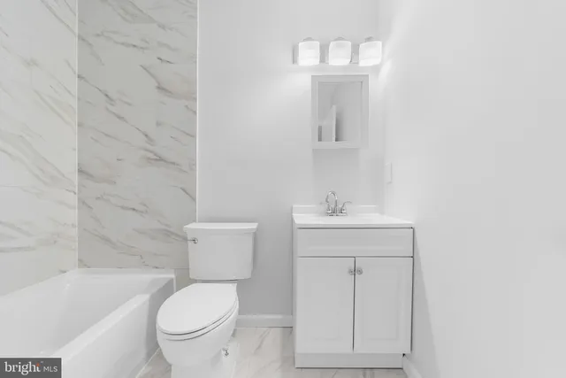 a bathroom with a bathtub and a toilet