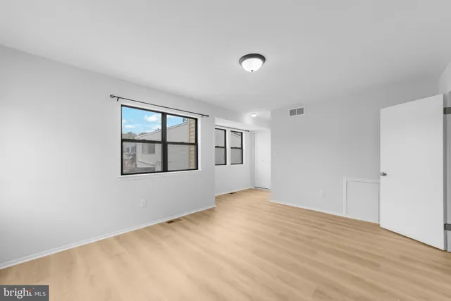 a view of walk in closet with empty racks