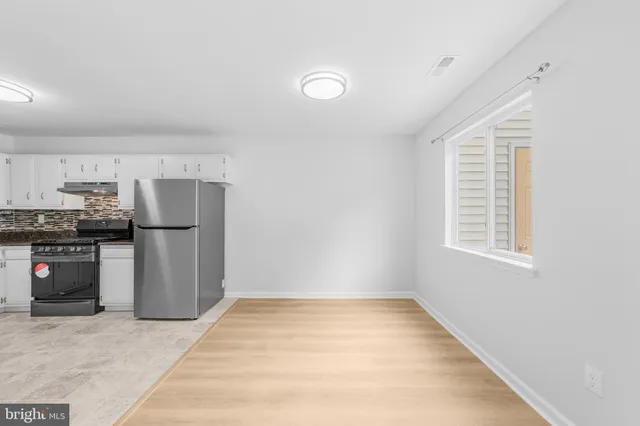 a kitchen with stainless steel appliances a refrigerator and a stove