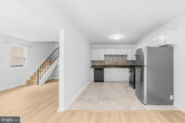 a view of kitchen with refrigerator and microwave