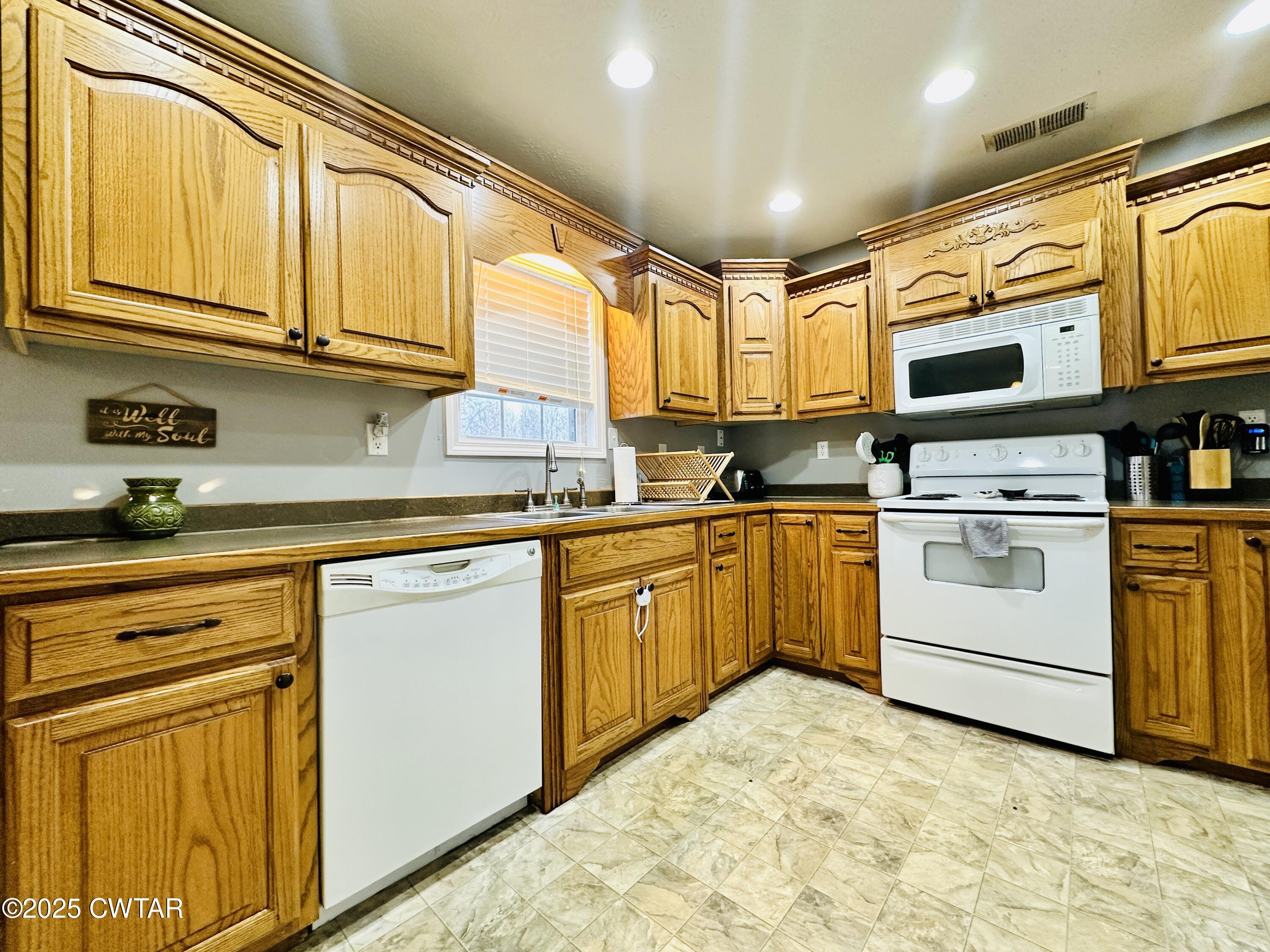 75 Bray Lane Beech Bluff, TN 38313 - Photo 11 of 25 a kitchen with white cabinets and white appliances