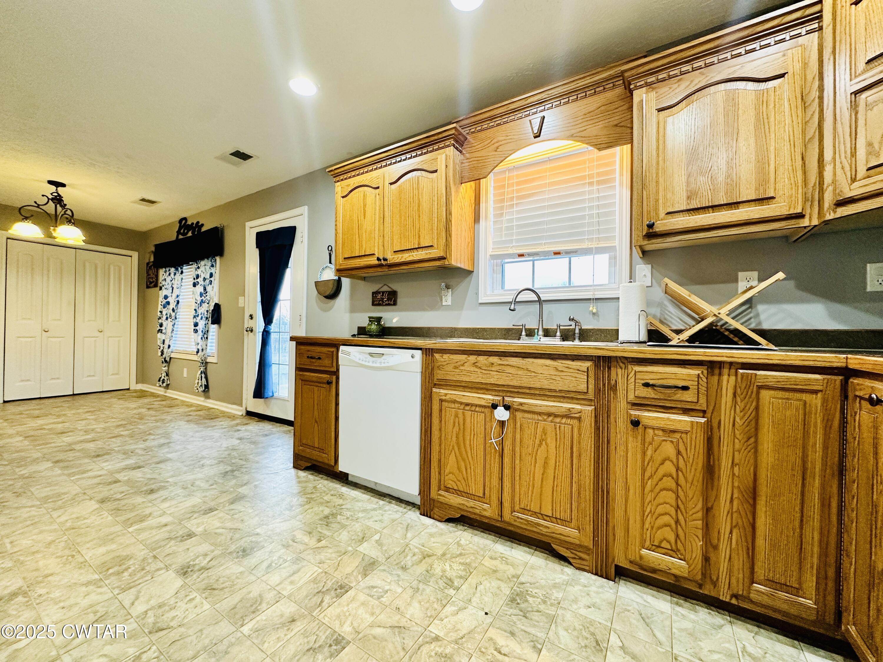 75 Bray Lane Beech Bluff, TN 38313 - Photo 12 of 25 a kitchen with stainless steel appliances granite countertop a sink and cabinets