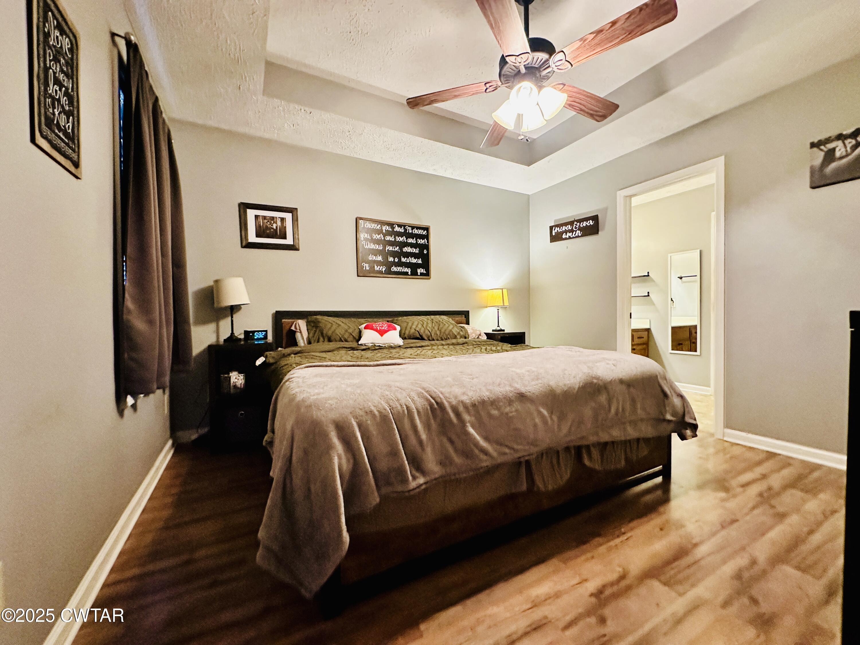 75 Bray Lane Beech Bluff, TN 38313 - Photo 14 of 25 a spacious bedroom with a bed and a chandelier