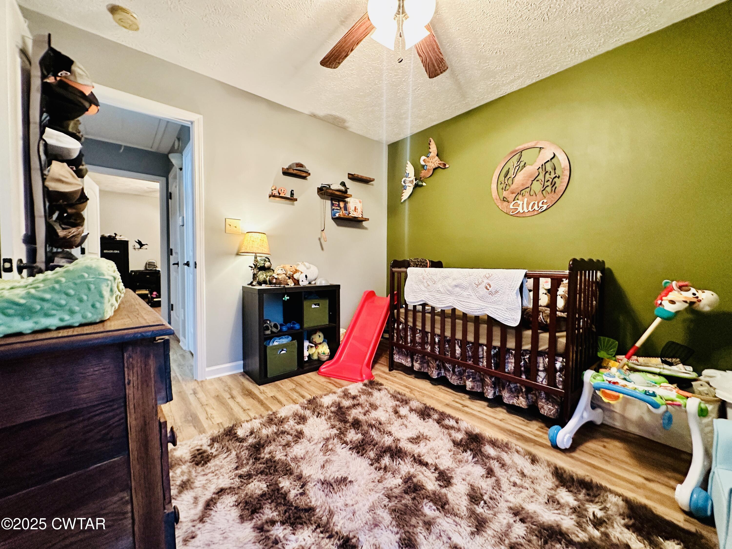 75 Bray Lane Beech Bluff, TN 38313 - Photo 19 of 25 a bedroom with a bed and a chandelier